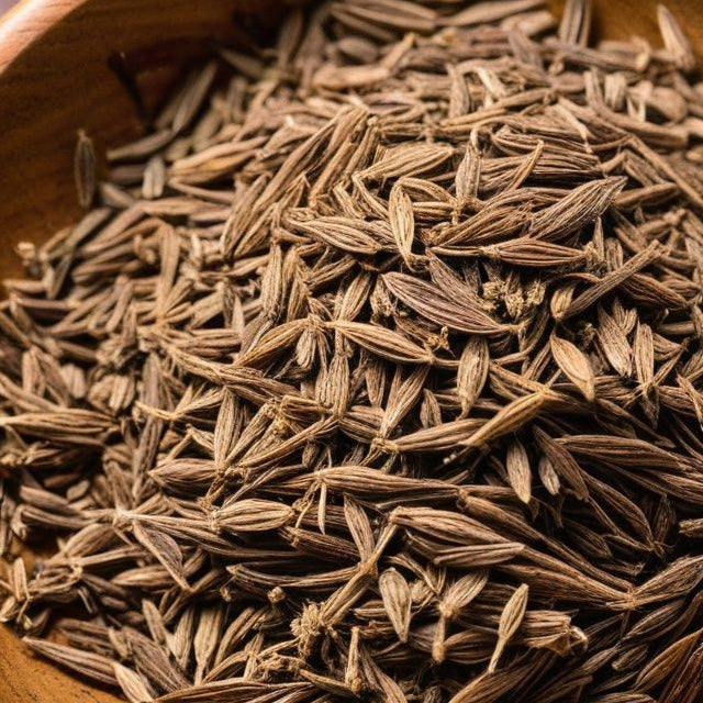 Dried cumin seeds in a wooden bowl